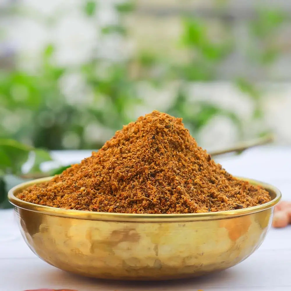 Spice mix in a brass bowl with a blurred natural background