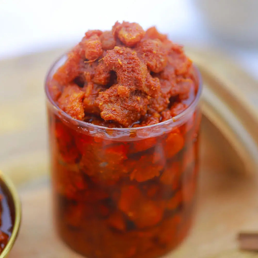 Jar of boneless chicken pickle on a wooden surface with blurred background