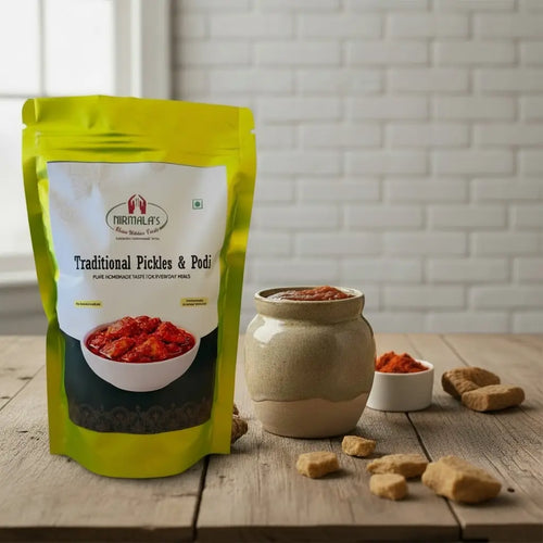 Packaged traditional pickles with a jar of allam pickle and ingredients on a wooden surface.